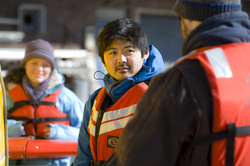 Justin Fujii and Sean Kelley preparing Sentry for launch at the WHOI dock.