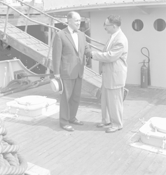 Edward Smith (L) shaking hands with unidentified man aboard R/V Crawford.