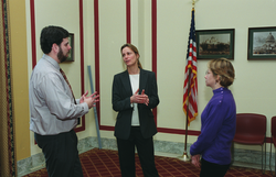 Ruth Curry (center) speaking with attendees at the briefing