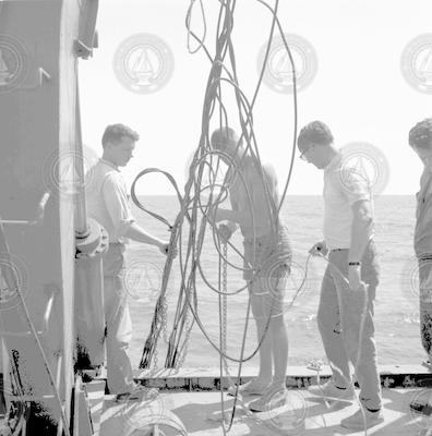 Dick Colburn (left) and unidentified men deploying instrument, sorting cable