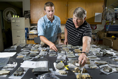 SSF Benjamin Urann looking over rock specimens with Henry Dick.