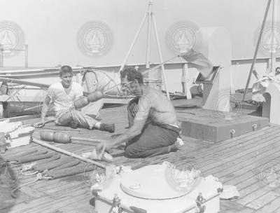 Herman Tasha (r) and George Hilton working on deck