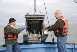Phil Alatalo and Robert Campbell launching a plankton sampling instrument.
