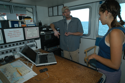 Captain Ken Houtler showing Orianna DeMasi Tioga electronics equipment.