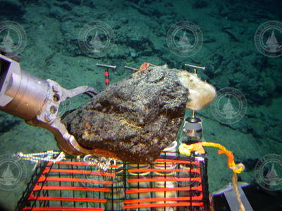 Manipulator arm grabbing a rock sample during Alvin dive 3798.