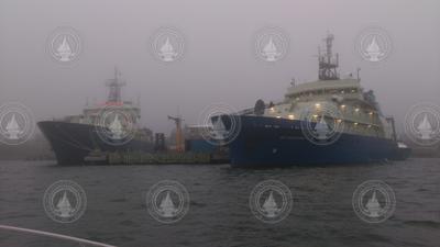 R/V Atlantis and R/V Neil Armstrong at the WHOi dock on a foggy day.