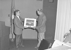 John Steele presenting Gordon Volkmann a thirty years of service award.