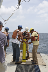 Peter Liarikos (center) and associates prepare to deploy an APEX float.
