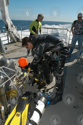 Ben Phillips preparing his diving equipment aboard Tioga.