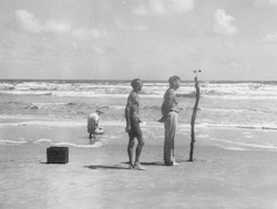 Al Woodcock (kneeling), Ted Spencer, and Andrew Bunker working on the beach.