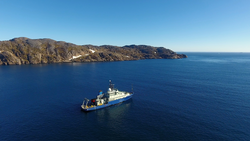 Aerial drone image of R/V Neil Armstrong leaving Prince Christian Sound.