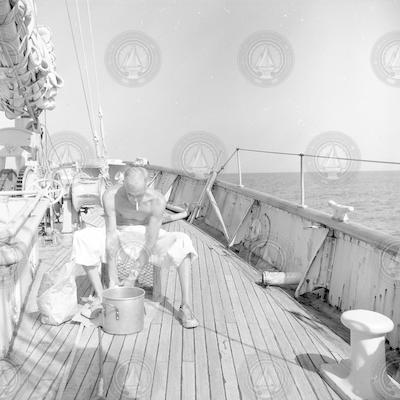 Brooks Coughlin washing clothes on fore deck of Atlantis.