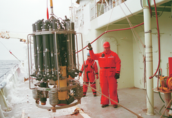 Shelley Ugstad and Marshall Swartz (front) deploying a CTD water sampling rosette.
