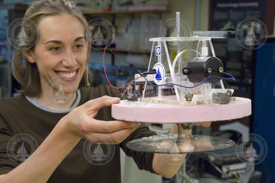 Stephanie Waterman holding her "beta boat" in GFD lab.