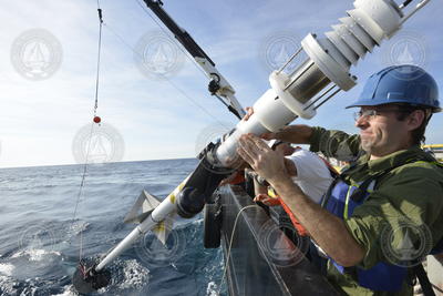 Larry George steadies the X-Spar buoy during deployment operations.