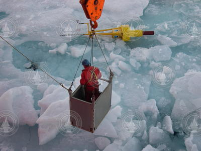 John Kemp recovering a buoy with a sensor package from the ice.