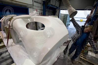 Victor Miller pulling an exhaust duct into position in high bay.