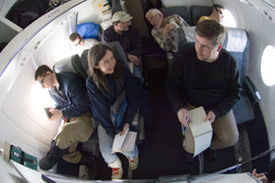 Plane cabin full of people on flight from Resolute Bay, Canada, to Canadian Forces Station Alert.