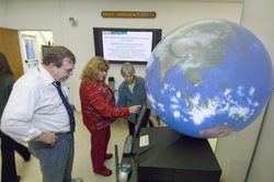 Kathy Patterson (in red) demonstrating the Magic Planet display.