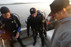 Pat Lohman and Jay Sisson confer with Rocky Geyer after locating his lost tripod.