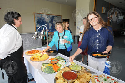 Mitzi Crane and Mary Zawoysky helping themselves to the food buffet.