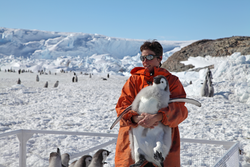 Stepanie Jenouvrier holding a five-month-old emperor penguin.