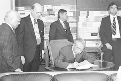 Emperor Hirohito signing a copy of his book.