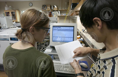 Emma Teuten and Li Xu working in the NOSAMS facility.