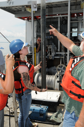 Student Amanda O'Rourke learning coring techniques from Bruce Tripp.