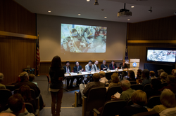 An audience member asking the panel of scientists a question.