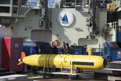 The NSF visitors are shown a REMUS 6000 on the dock.