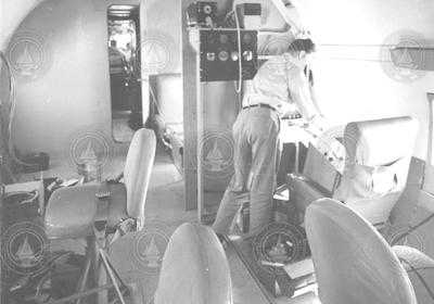 Interior view of C54Q aircraft, unidentified man working on board