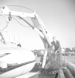 Jacques Cousteau maneuvering crane with saucer