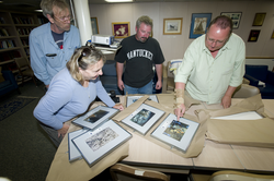 Chris German presents Atlantis Master Mitzi Crane and crew with framed photos.