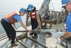 Phil Alatalo helps Sophie Reuhr and Adrynne Jones recover the gravity corer.