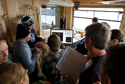 Researchers learning how to guide a CTD mission using the computer interface.