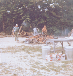 Group working on clambake fire