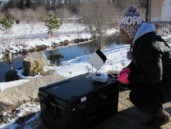 Postdoc Erika Johnson operating the drone to survey the Coonamessett river.
