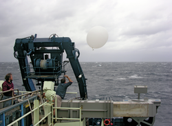 John Toole observes Jim Edson deploy a radiosonde weather balloon from Atlantis.