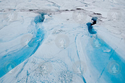 Ice water channels flowing into draining moulins.