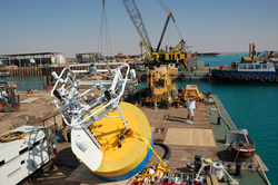Mooring buoy and other components loaded onto a barge for deployment.