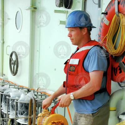 Peter de Menocal working a deck winch on board R/V Oceanus.