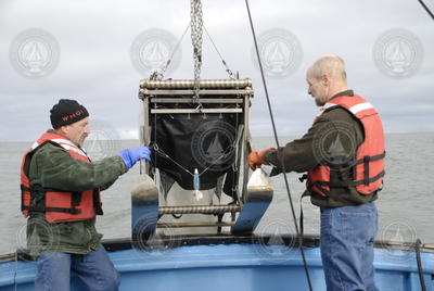 Phil Alatalo and Robert Campbell launching a plankton sampling instrument.