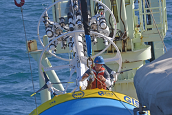 Kris Newhall attaching Global Surface Mooring buoy to quick release for deployment.