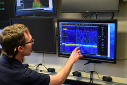 Dan Lizarralde examining EK80 echosounder data on a monitor.