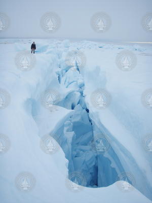 Ian Joughlin posing near a large ice fracture.