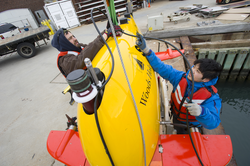 Sean Kelley and Justin Fujii preparing AUV Sentry for dock tests.