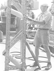 Harold Edgerton adjusting strobe equipment.