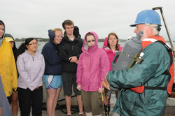 Bruce Tripp teaching students about Niskin bottle water sampling.