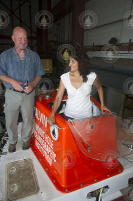 Tim Shank watches as Dina Pandya enters the Alvin hatch in the high bay.